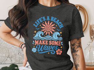Dark grey t-shirt graphic with text "Life's a beach make some waves" and beach imagery.
