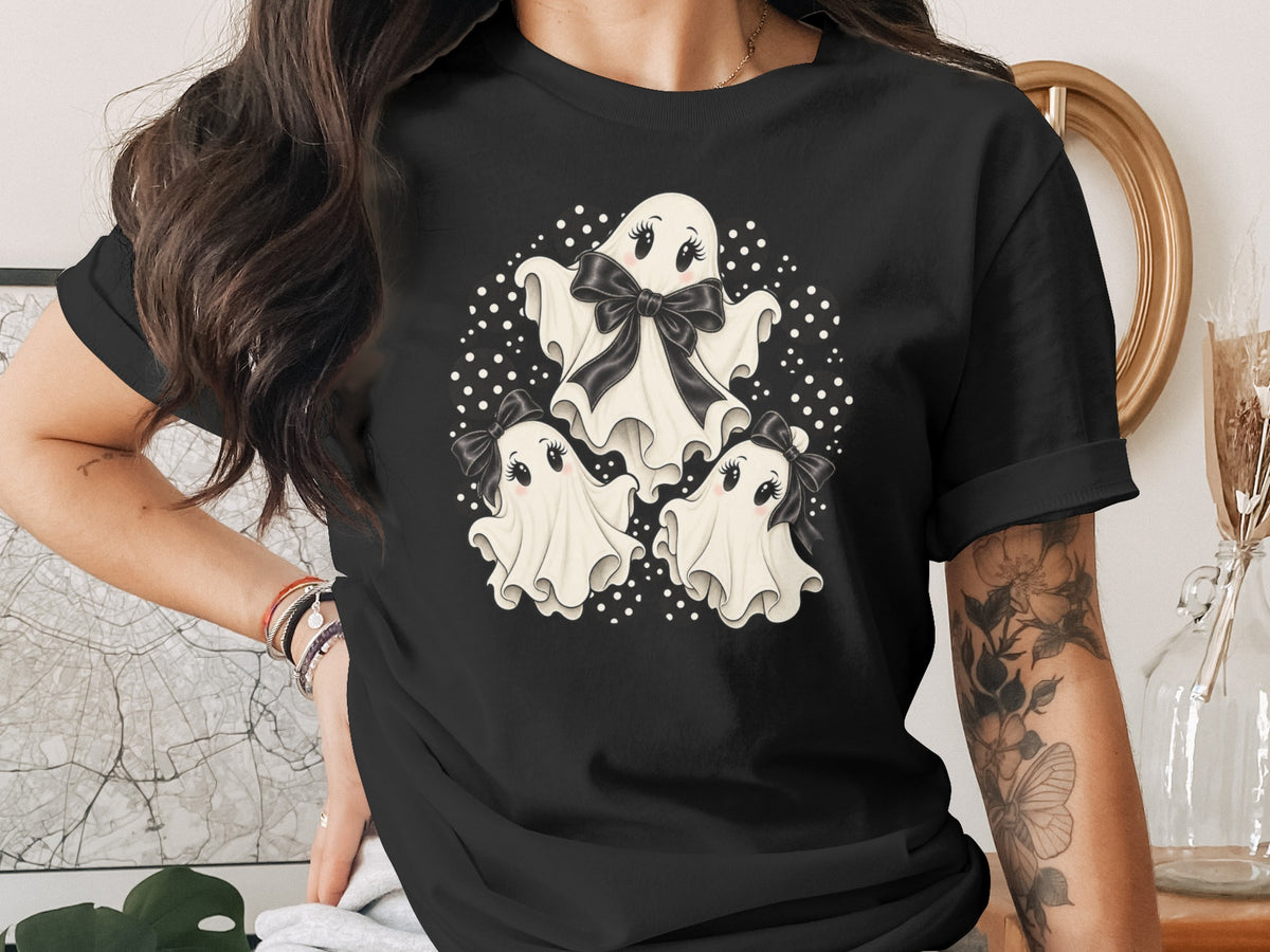 Black t-shirt with three cartoon ghosts and black bows, surrounded by polka dots.