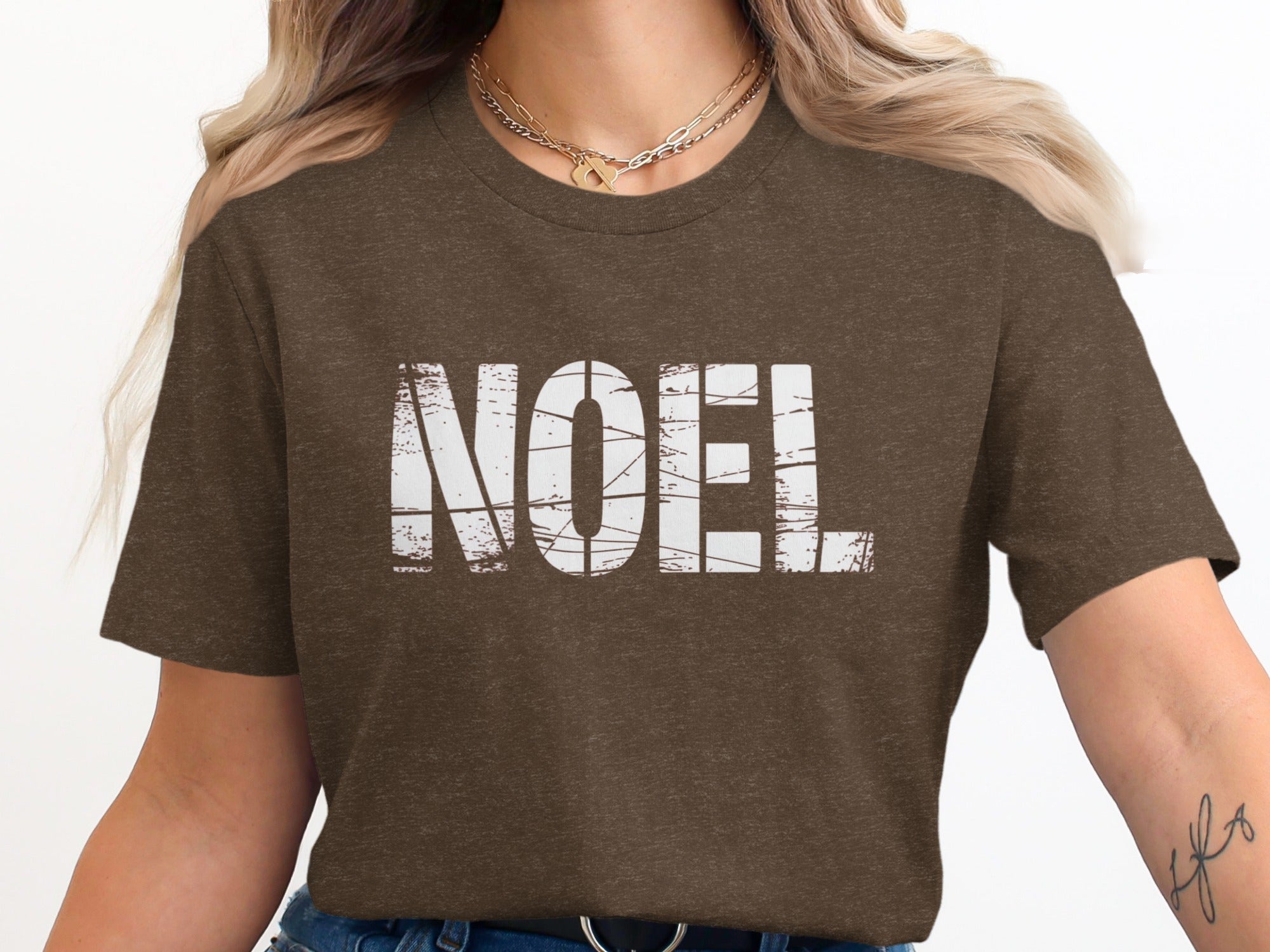 Brown t-shirt with distressed white "NOEL" text