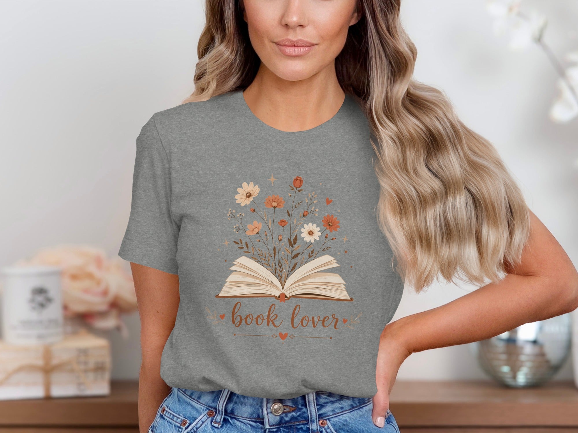 Grey t-shirt with an open book design surrounded by flowers and the text "book lover".