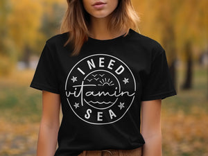 Black t-shirt with white text and graphics reading "I NEED vitamin SEA".