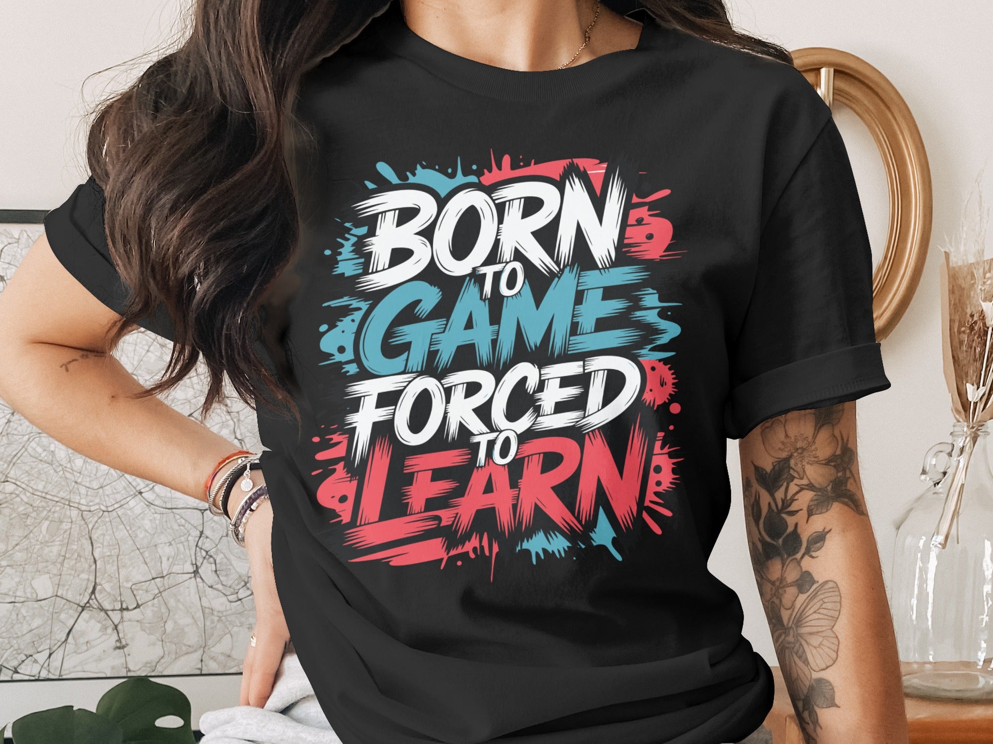 Black t-shirt with "Born to Game Forced to Learn" text graphic.