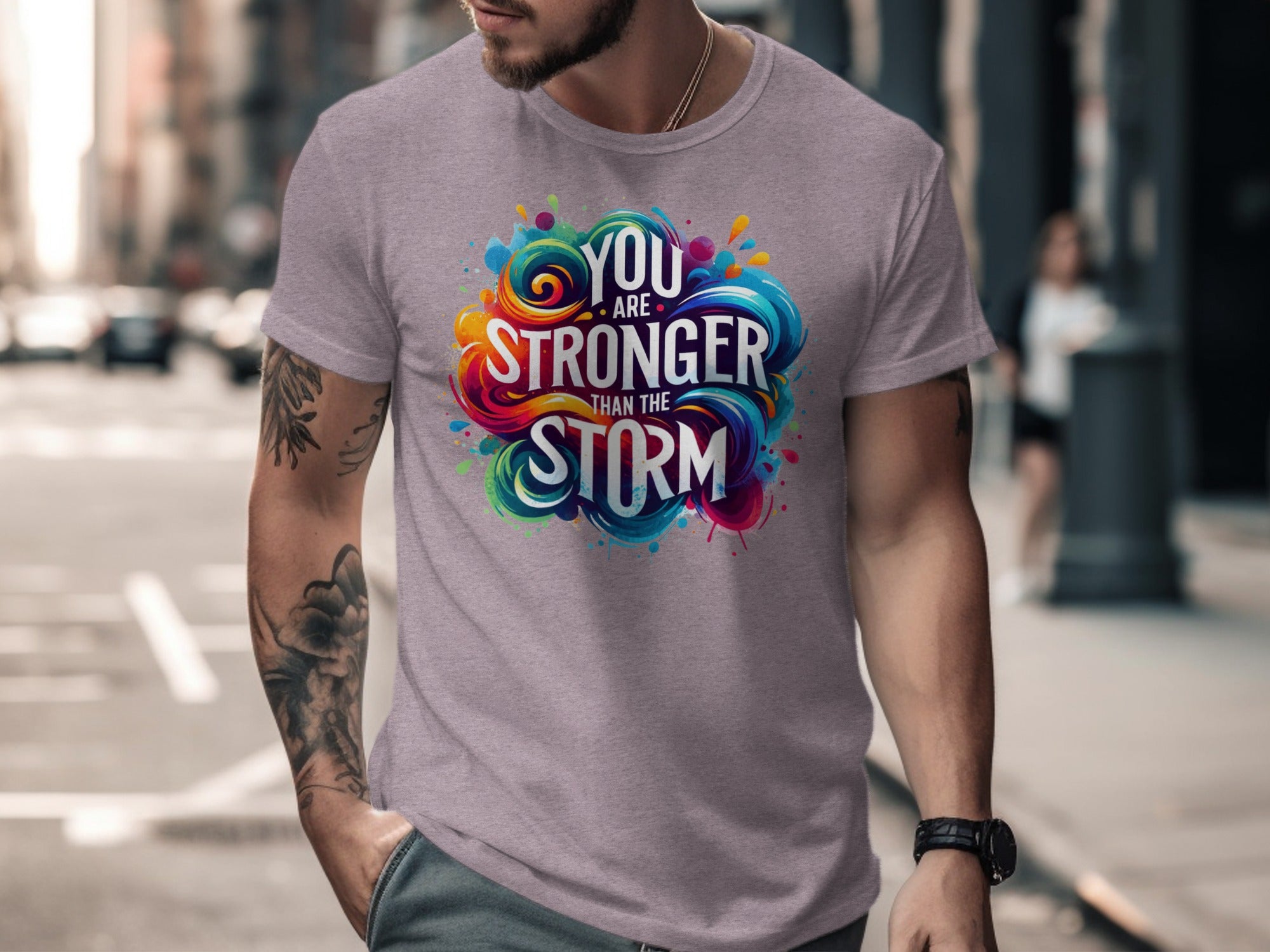 Gray t-shirt with colorful "You are stronger than the storm" text graphic.