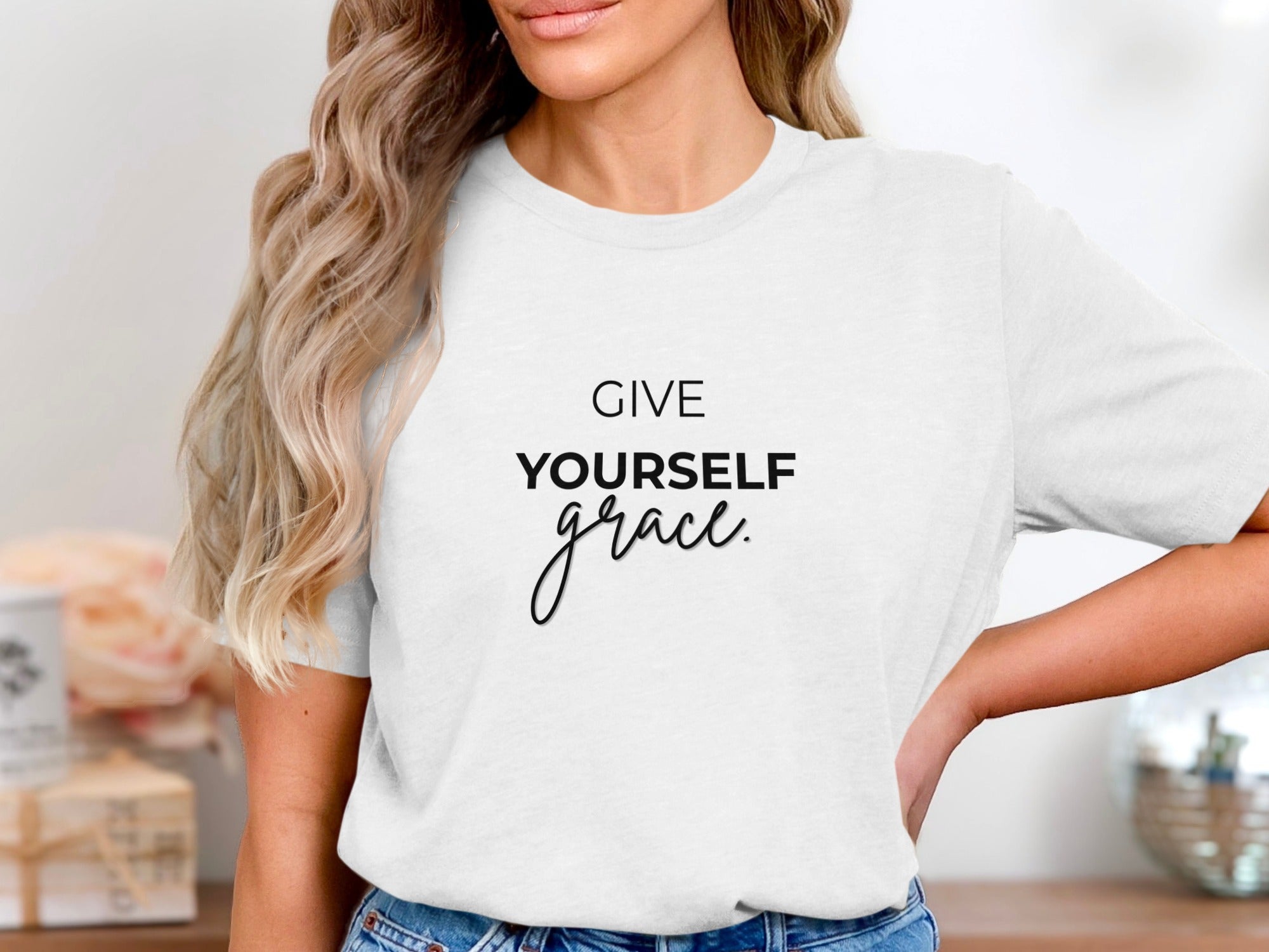 White t-shirt with black text that reads "GIVE YOURSELF grace."