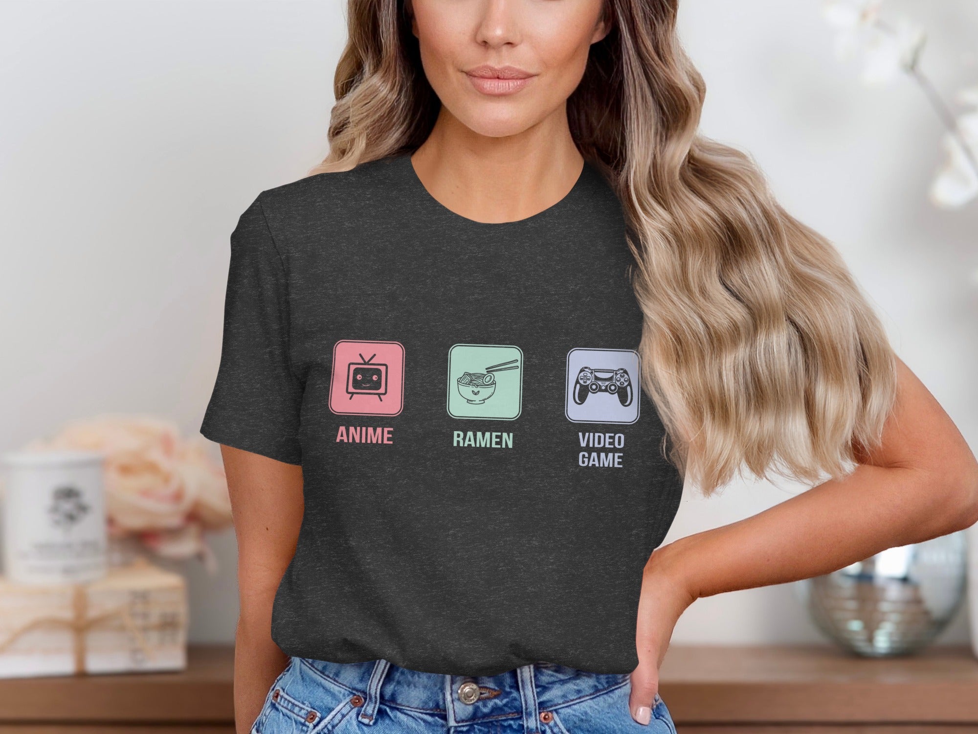 Dark grey t-shirt with three framed icons of anime, ramen, and video games.