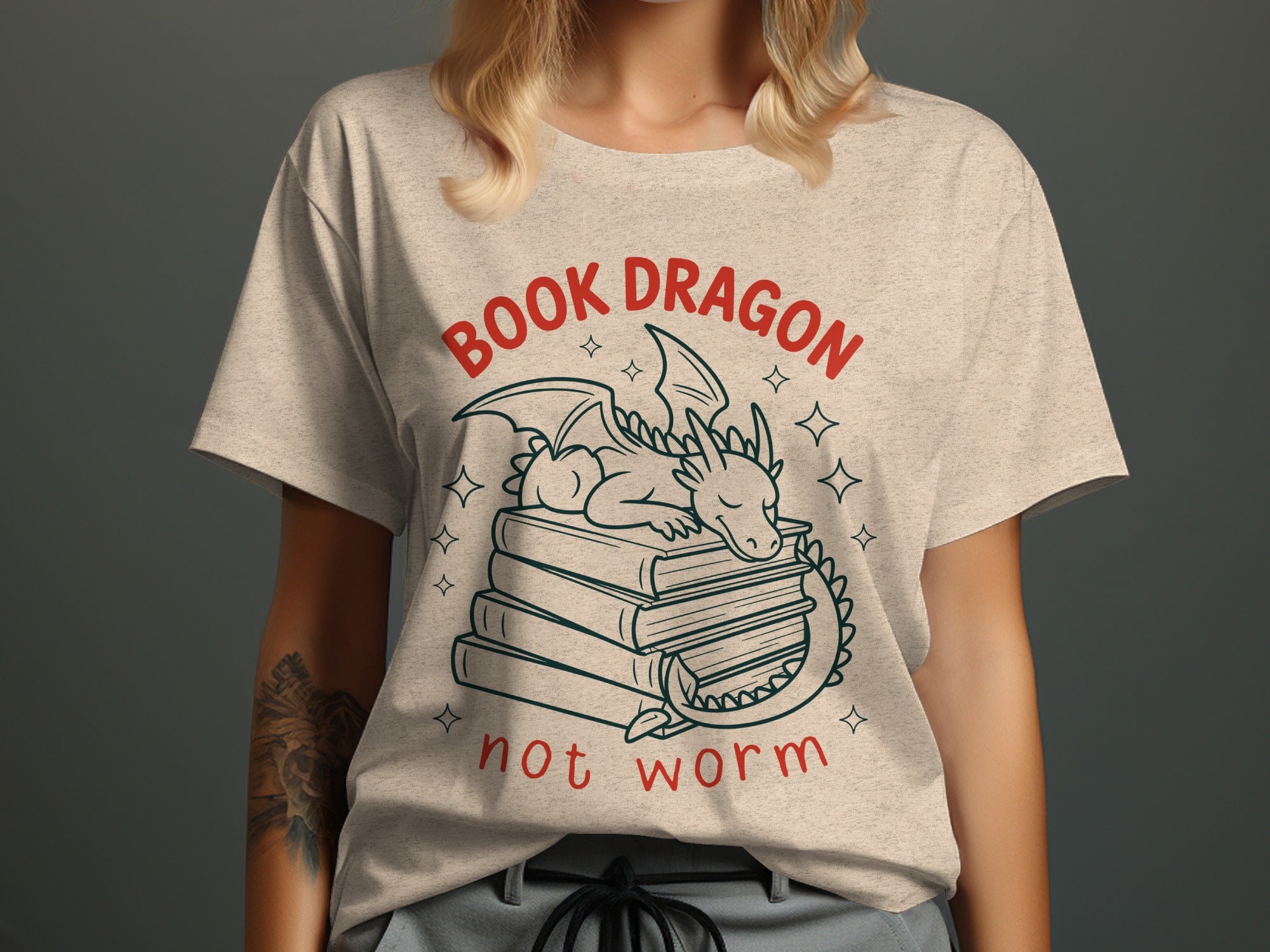 T-shirt with text "BOOK DRAGON not worm" and a sleeping dragon on books.
