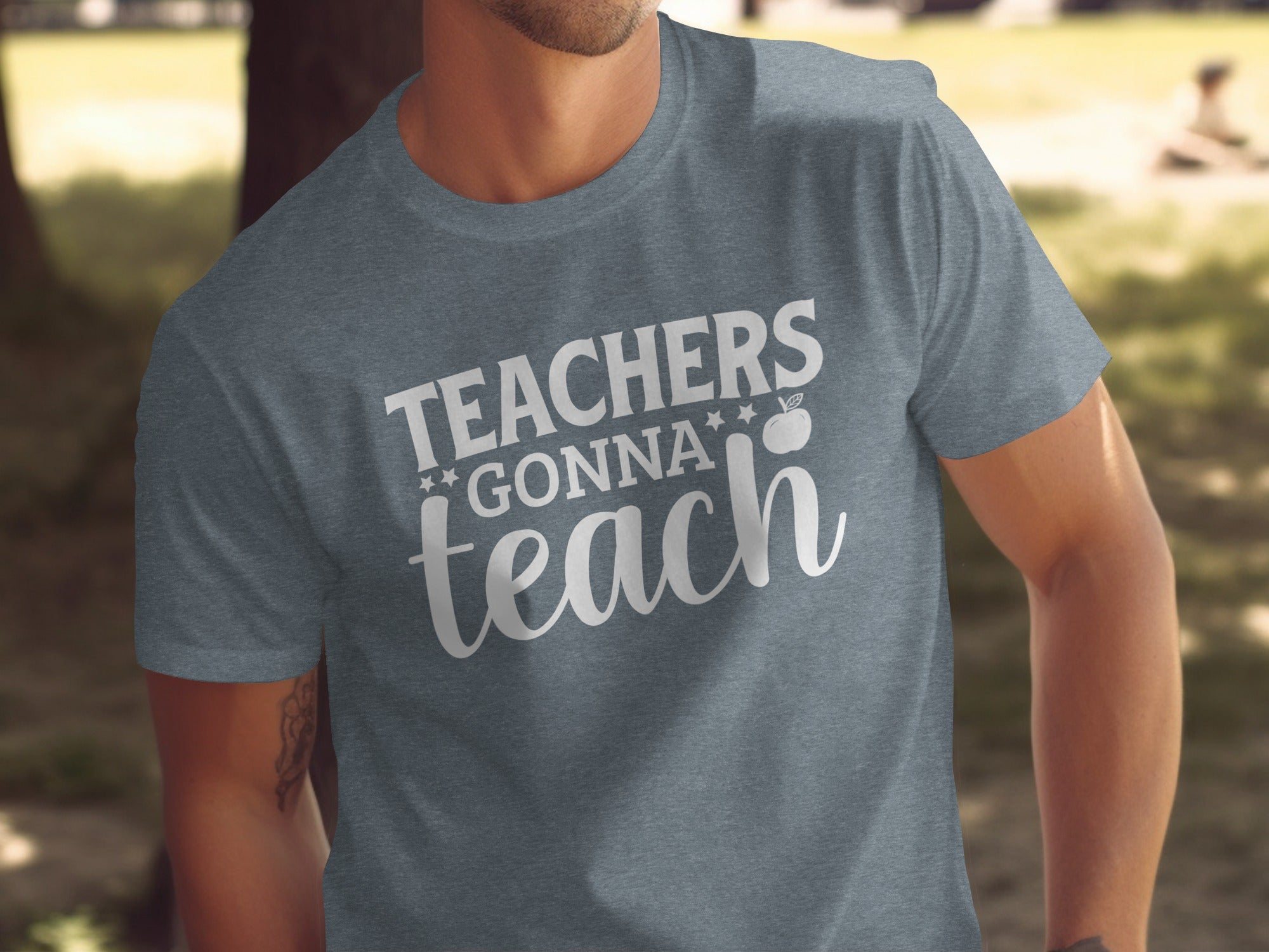 Grey t-shirt with white text "Teachers Gonna Teach" and an apple graphic.