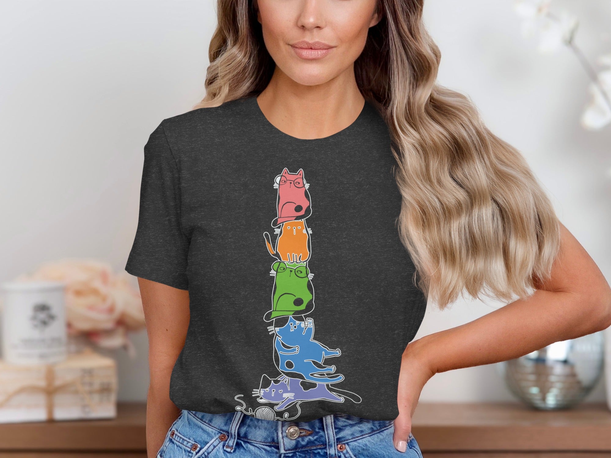 Dark gray t-shirt with a stack of colorful, stylized cats and a ball of yarn.