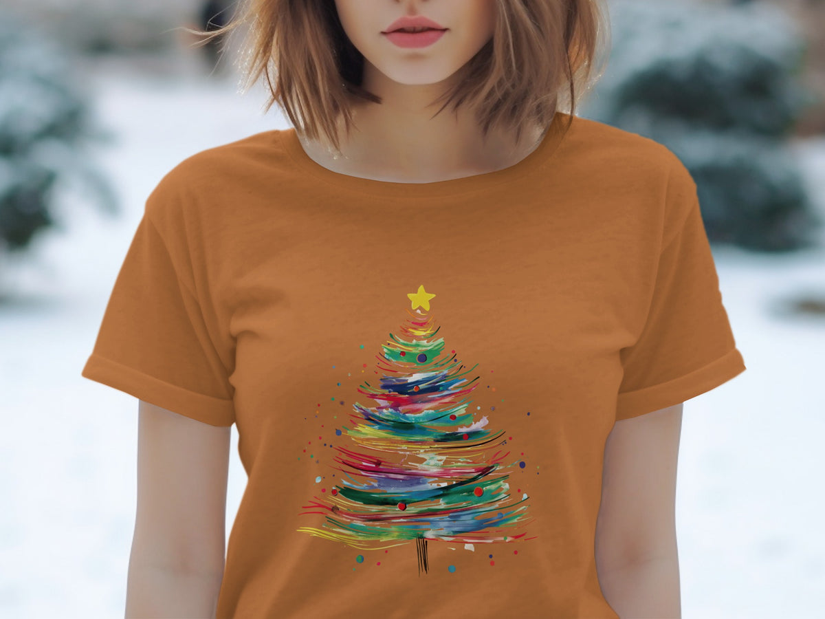 Orange t-shirt with a colorful abstract Christmas tree graphic and yellow star.