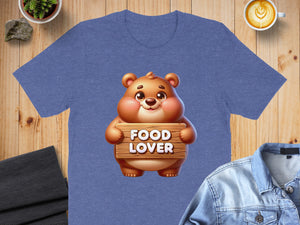Cartoon bear holding a sign that says "FOOD LOVER" on a blue t-shirt.