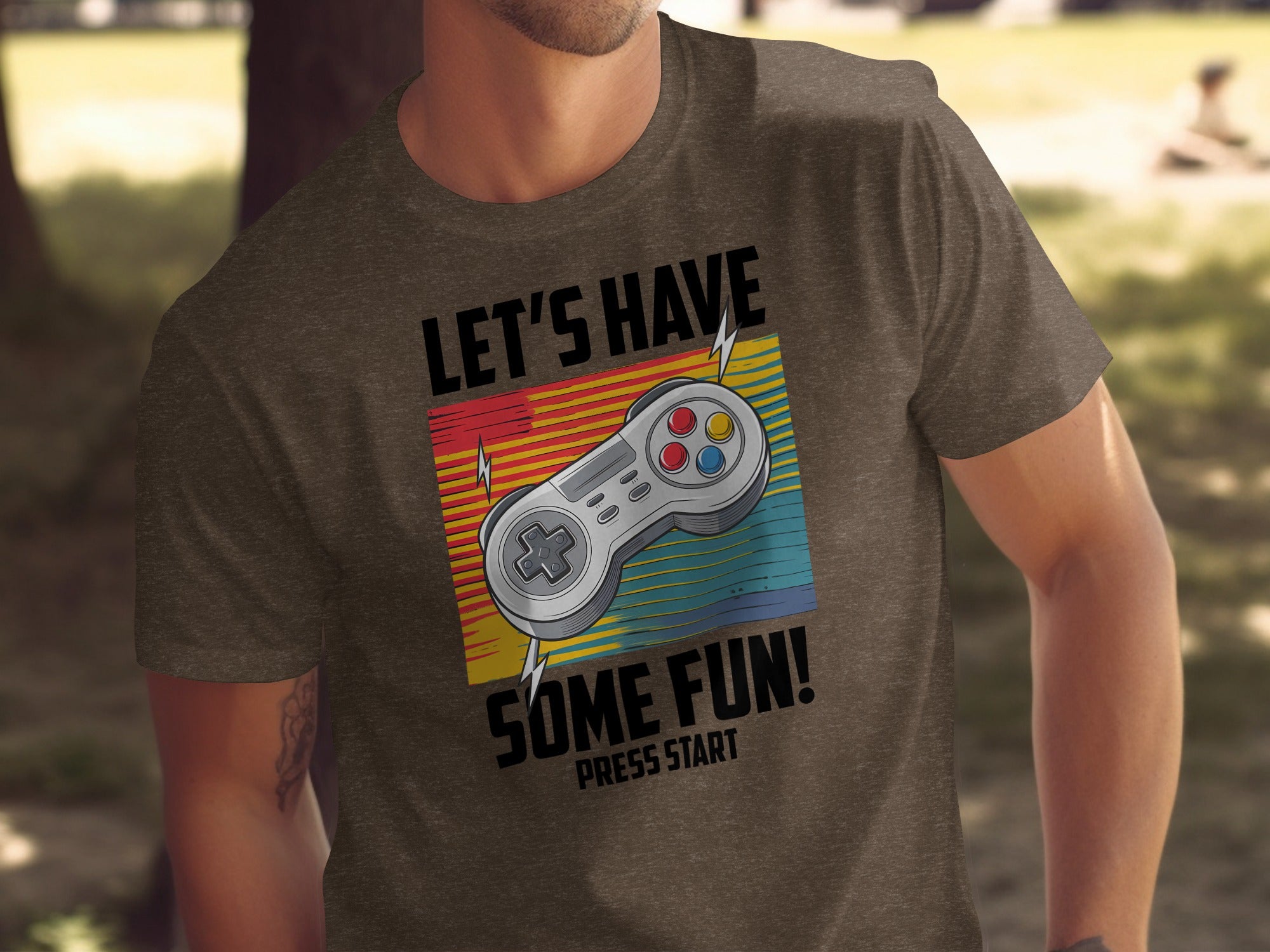 T-shirt with retro video game controller graphic and text "Let's Have Some Fun! Press Start."