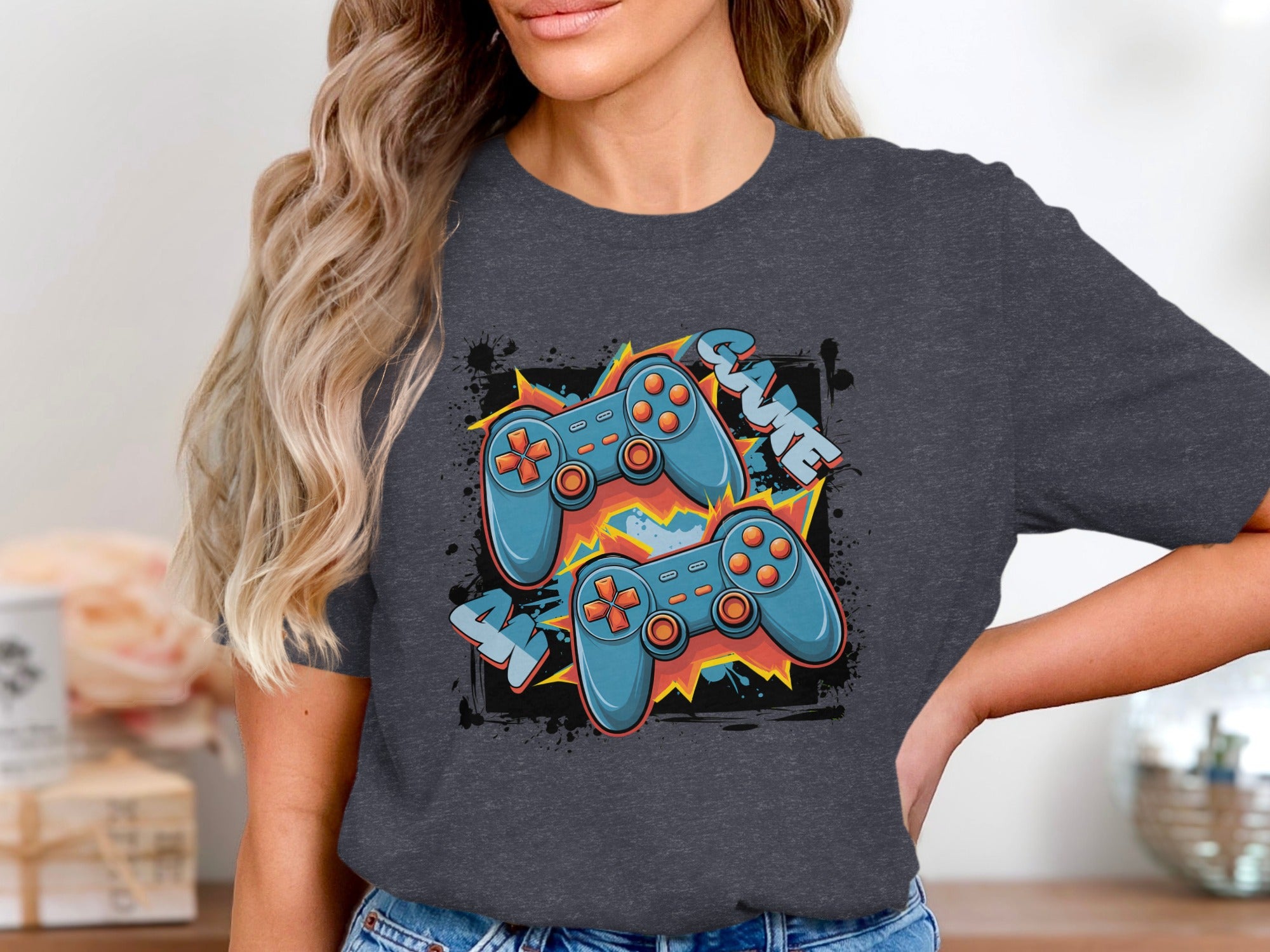 Two blue video game controllers with orange accents on a dark t-shirt.