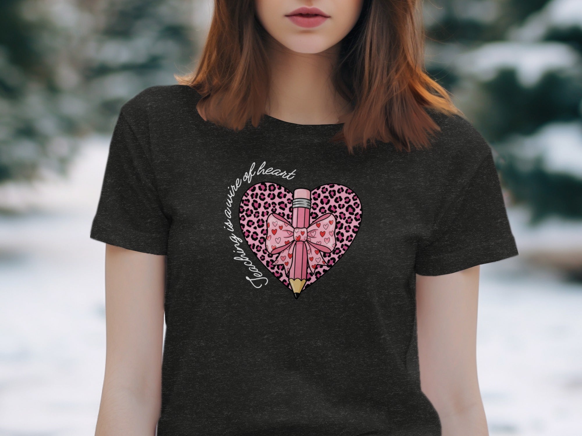 Dark t-shirt with a pink heart design featuring a pencil, bow, and leopard print.