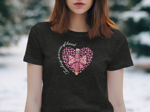Dark t-shirt with a pink heart design featuring a pencil, bow, and leopard print.