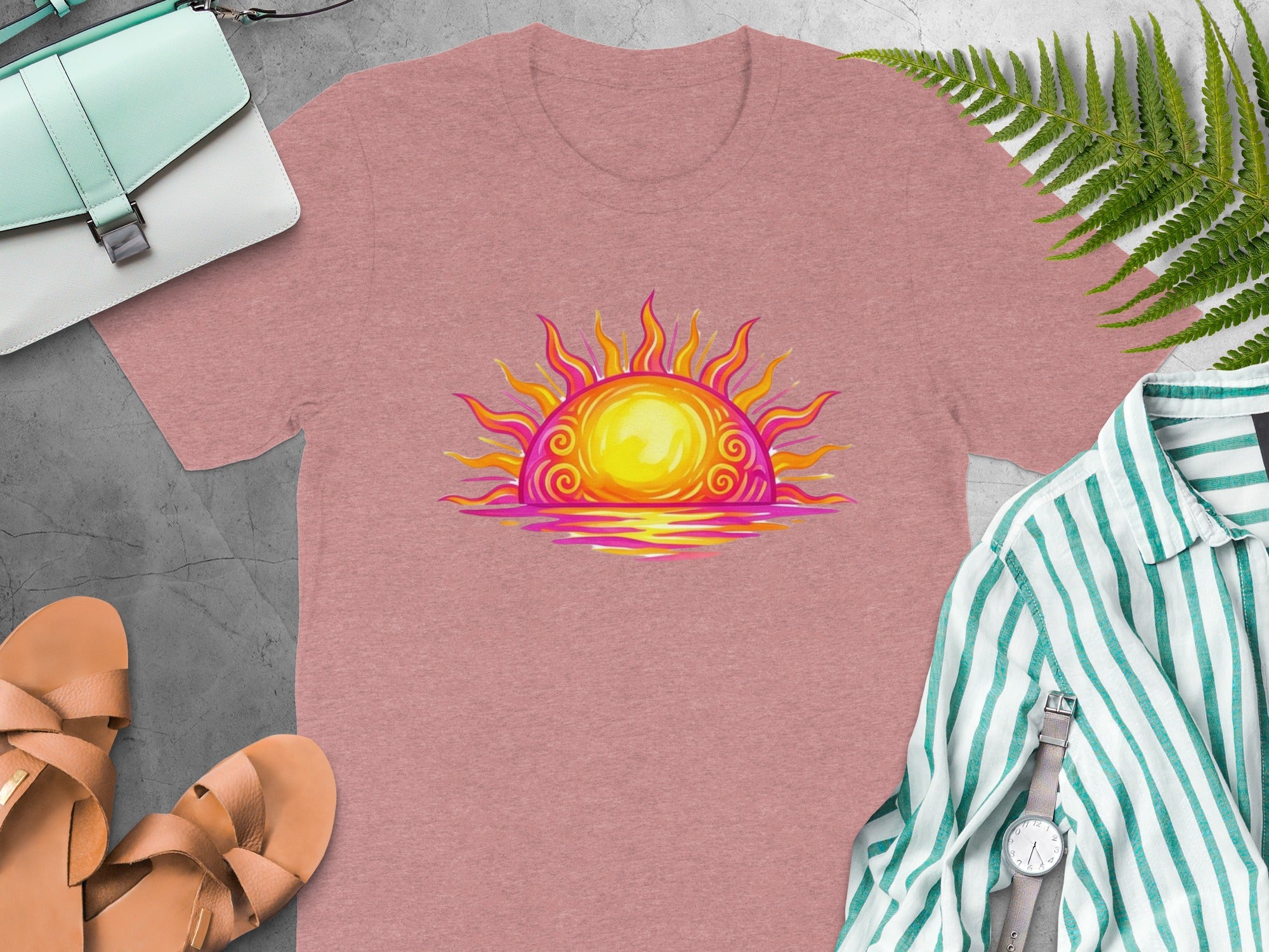 Pink t-shirt with a vibrant, stylized sun and water graphic.