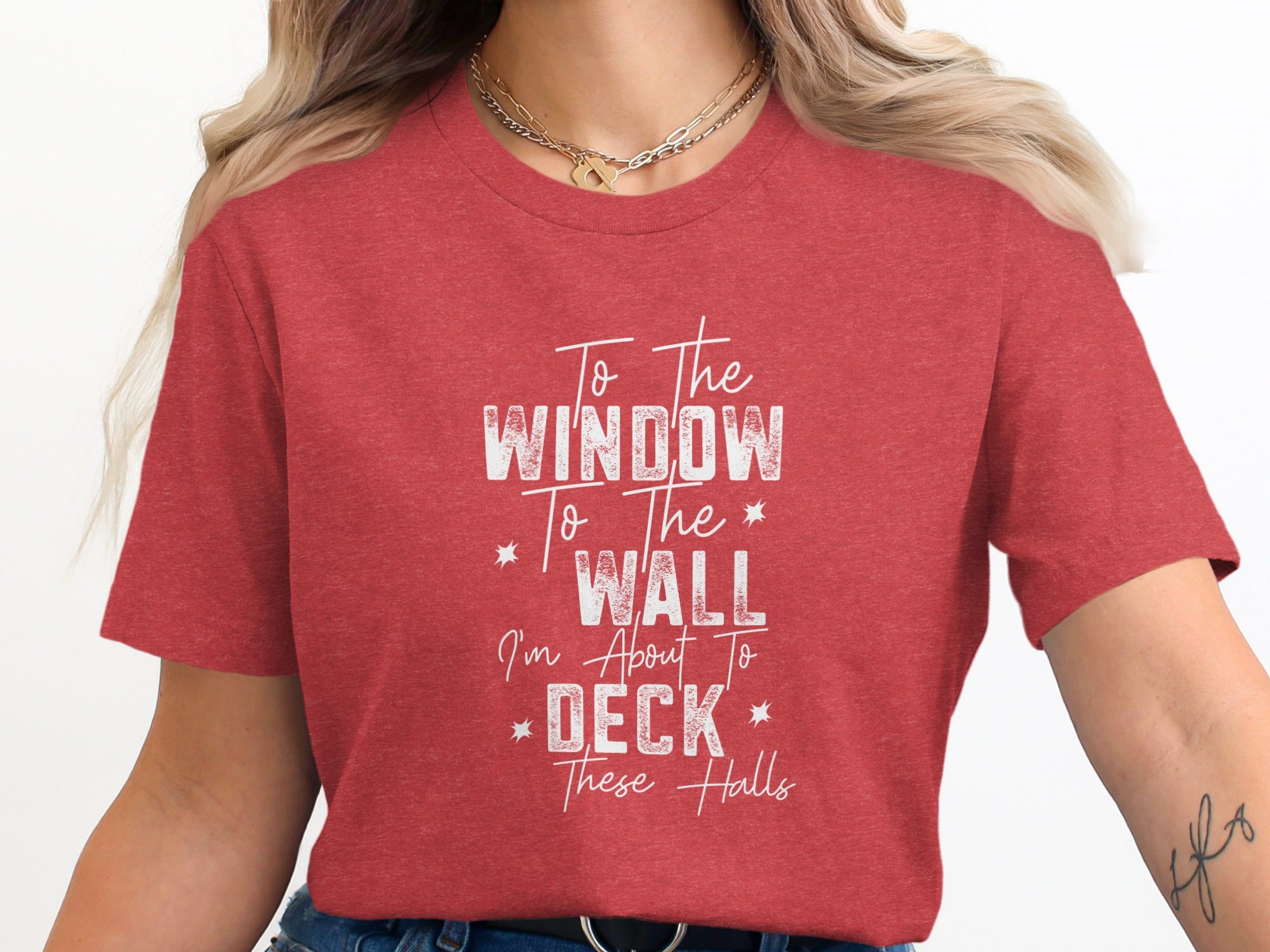 Red t-shirt with white text reading "To The Window To The Wall I'm About To Deck These Halls".