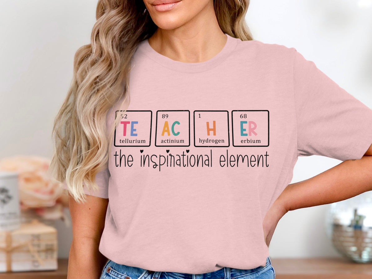 Pink t-shirt with "TEACHER" spelled using periodic table elements and "the inspirational element".