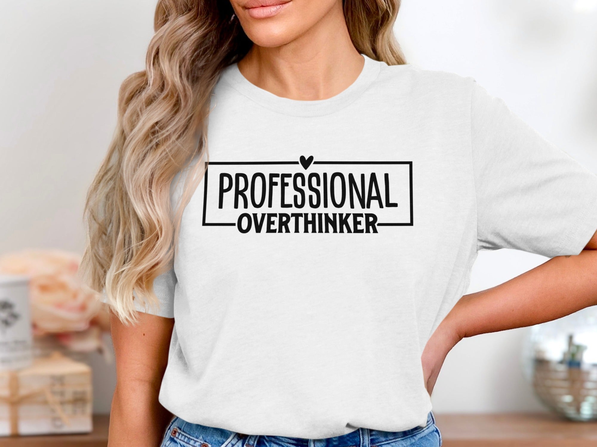 White t-shirt with black text: "PROFESSIONAL OVERTHINKER" inside a box.
