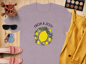 Purple t-shirt with lemon graphic and "FRESH & ZESTY" text.