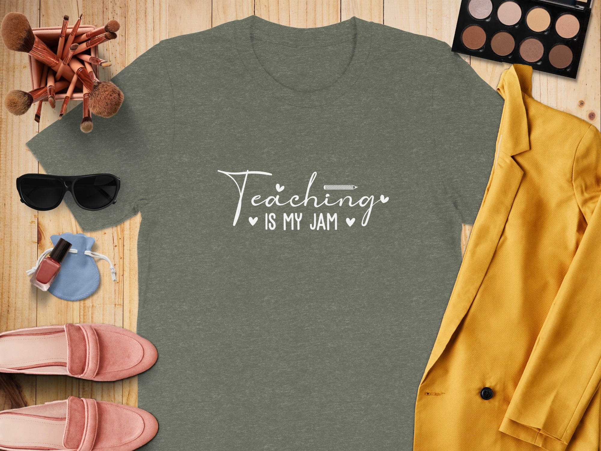 Green t-shirt with "Teaching is my jam" text, surrounded by fashion items.