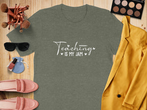 Green t-shirt with "Teaching is my jam" text, surrounded by fashion items.