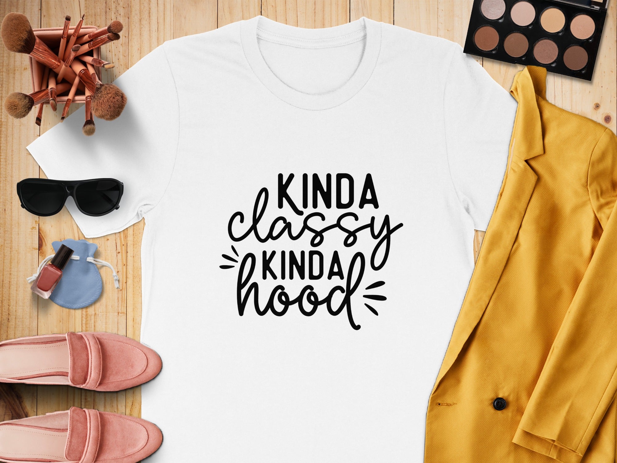 White t-shirt with "Kinda Classy Kinda Hood" text, flat lay with blazer, shoes, makeup.