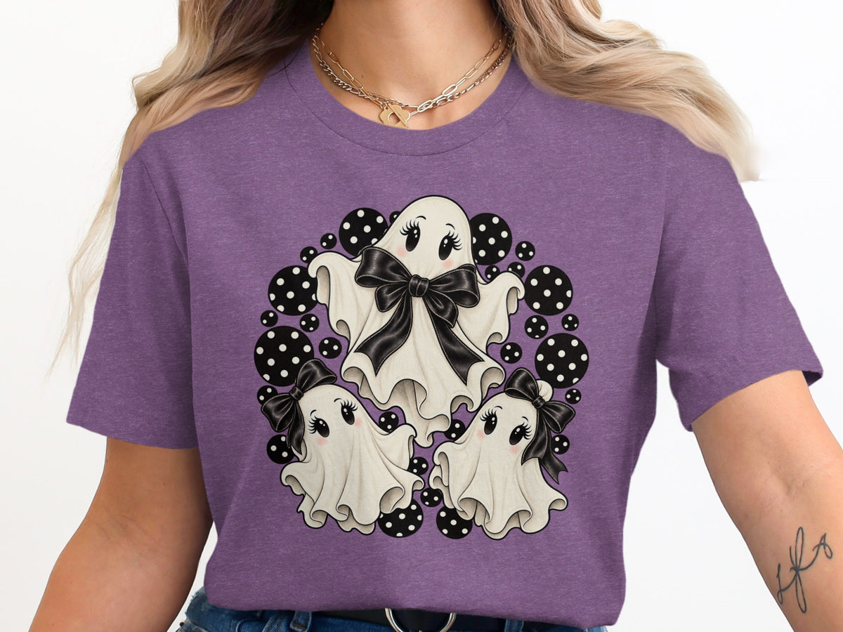 Three cute cartoon ghosts with bows surrounded by black and white polka dots.