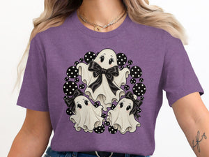 Three cute cartoon ghosts with bows surrounded by black and white polka dots.