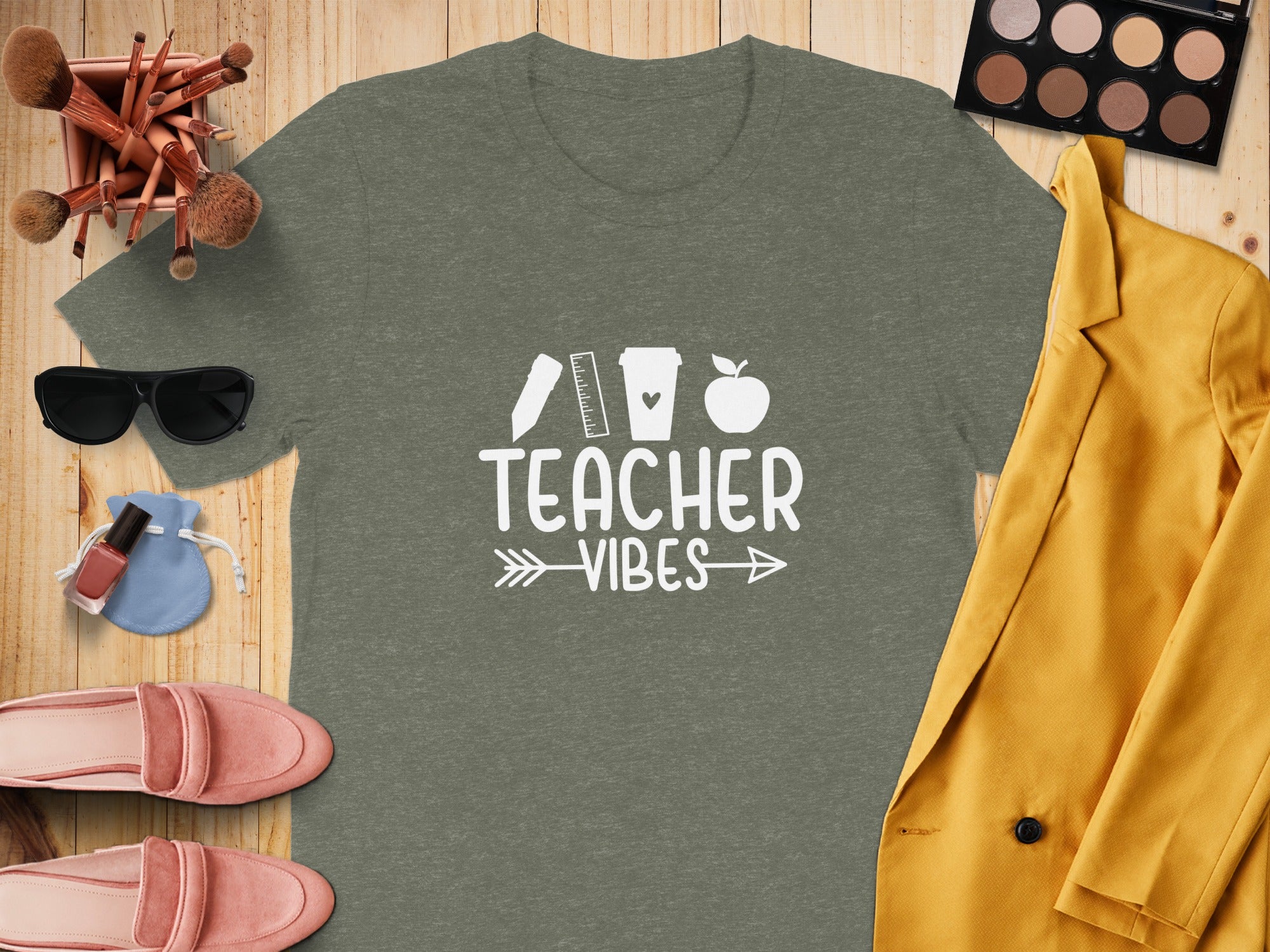 Olive green t-shirt featuring white "Teacher Vibes" text and icons.