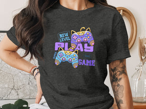 T-shirt graphic with cats playing video games and text "New Level Play Game."