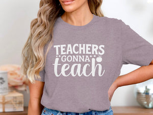 Mauve t-shirt with white text "Teachers Gonna Teach" and an apple graphic.