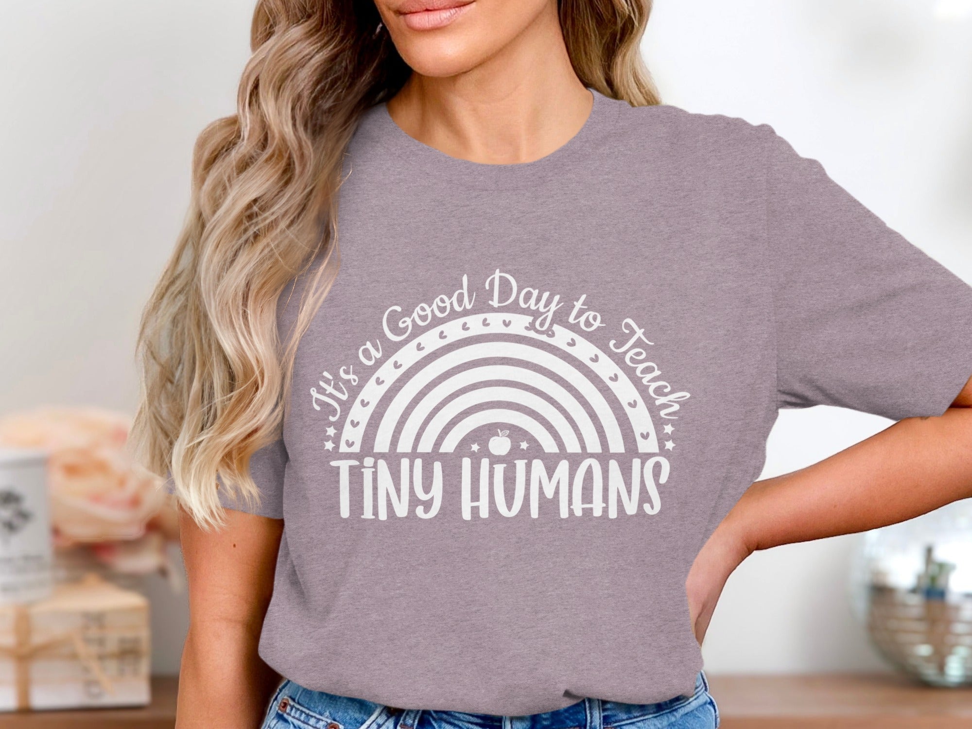 Purple t-shirt with a white rainbow graphic and text that reads "It's a Good Day to Teach TINY HUMANS".