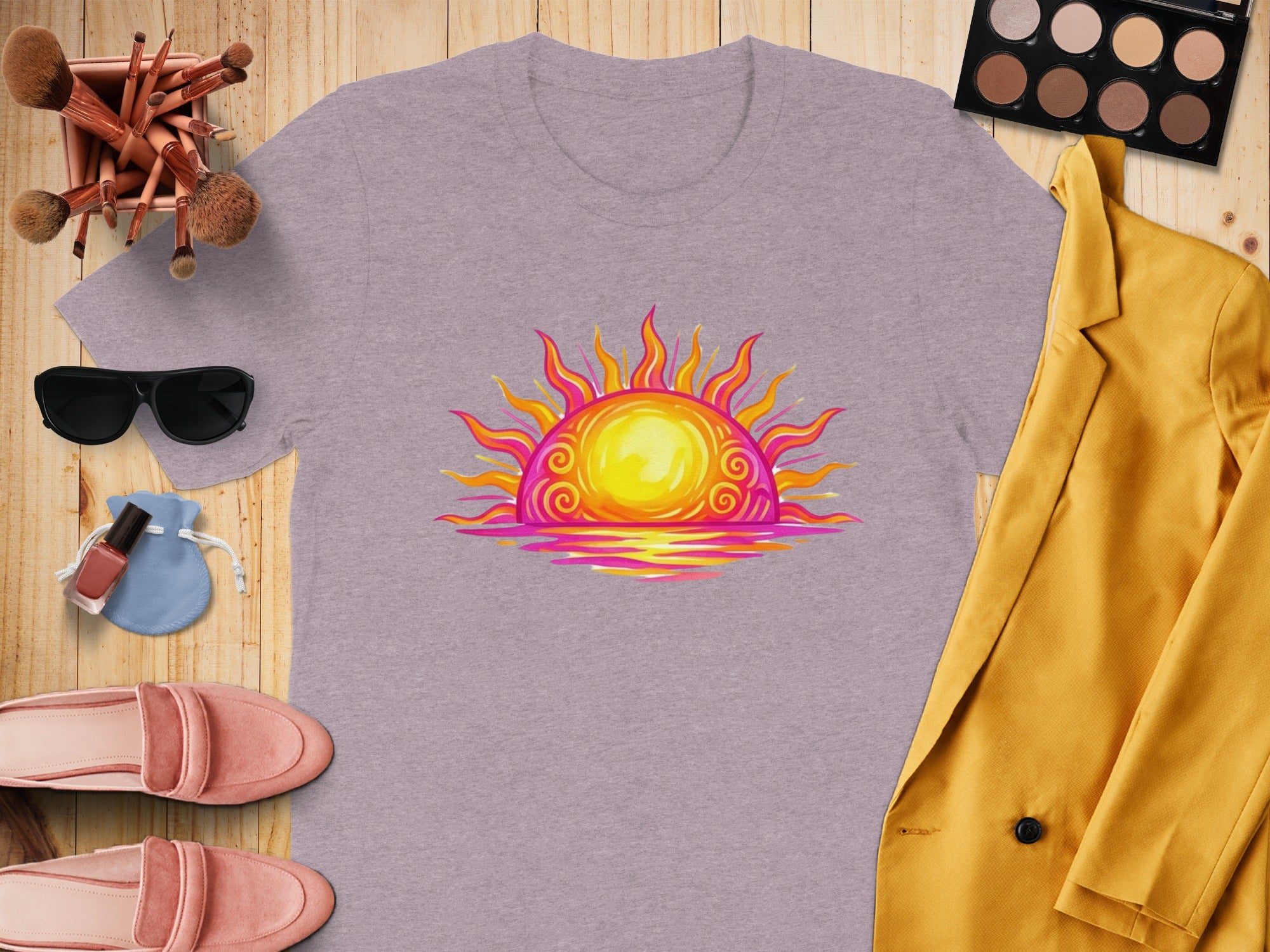 Lavender t-shirt with colorful sunrise graphic, surrounded by fashion items.