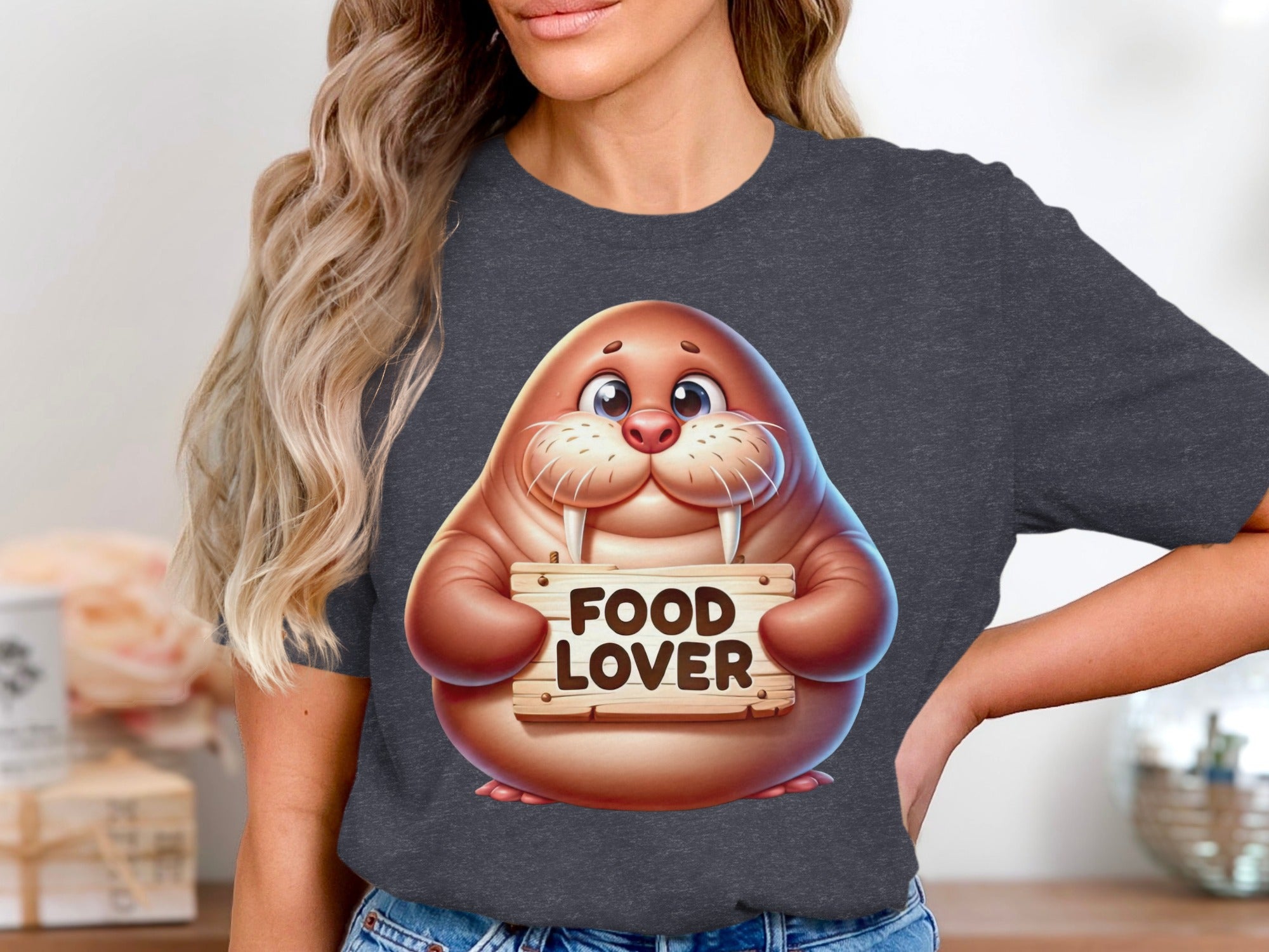 Cartoon walrus holding a "FOOD LOVER" sign on a dark grey t-shirt.