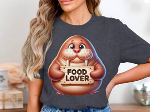 Cartoon walrus holding a "FOOD LOVER" sign on a dark grey t-shirt.