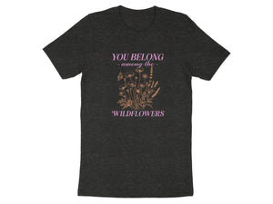 Dark t-shirt with "You Belong - among the - Wildflowers" text and delicate floral illustration.