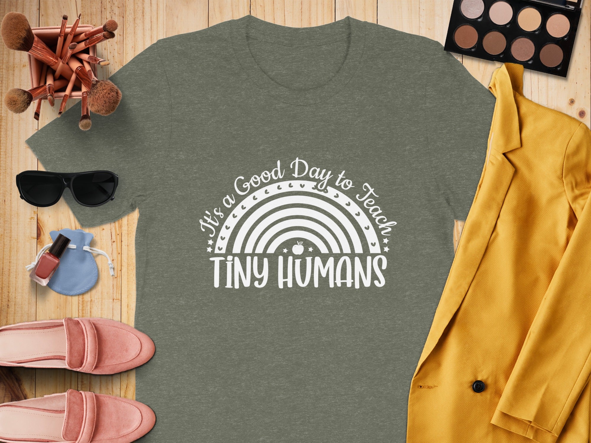 Olive green t-shirt with "It's a Good Day to Teach Tiny Humans" text and rainbow graphic.