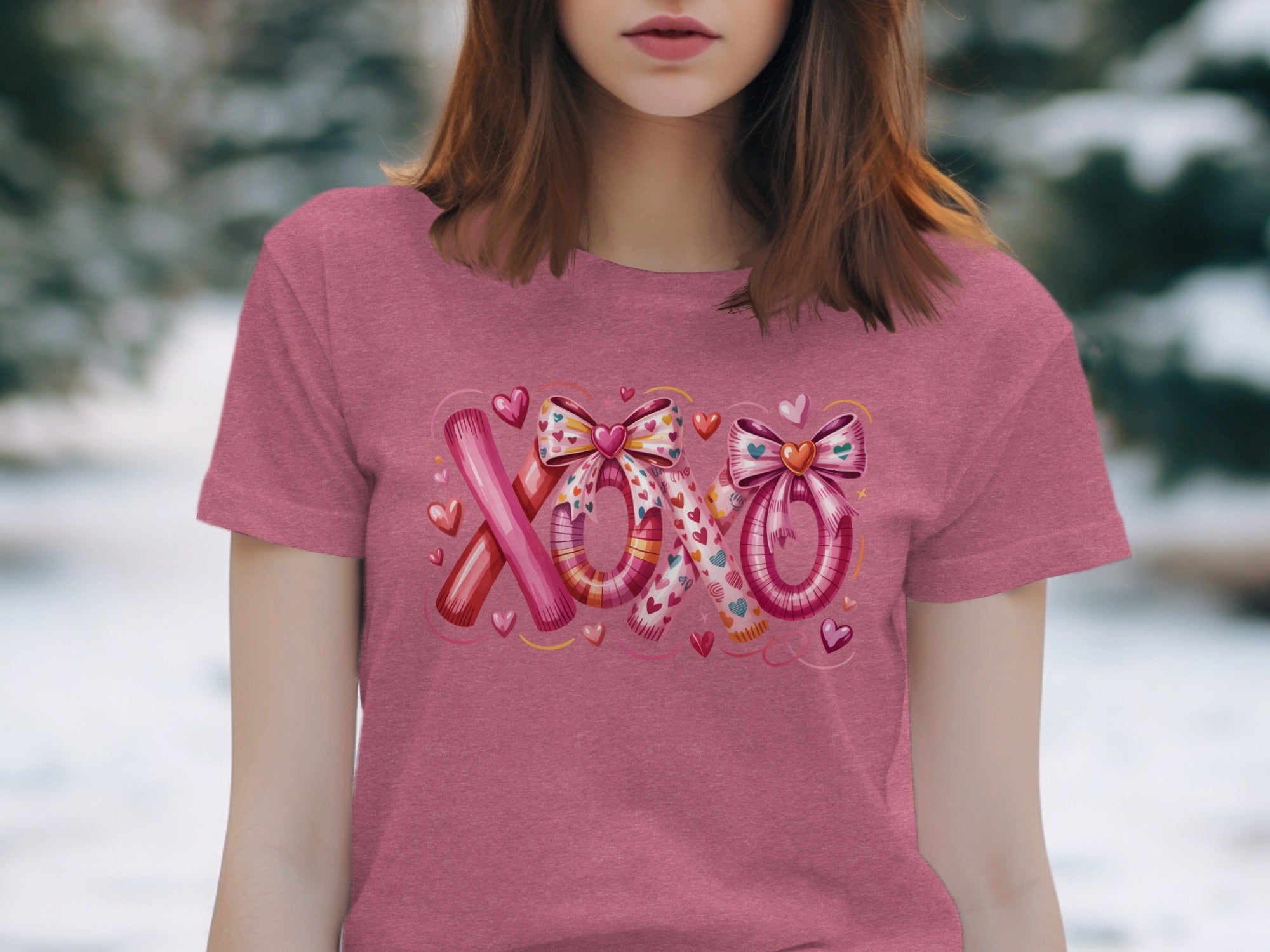 Pink t-shirt with "XOXO" text design featuring bows and hearts.
