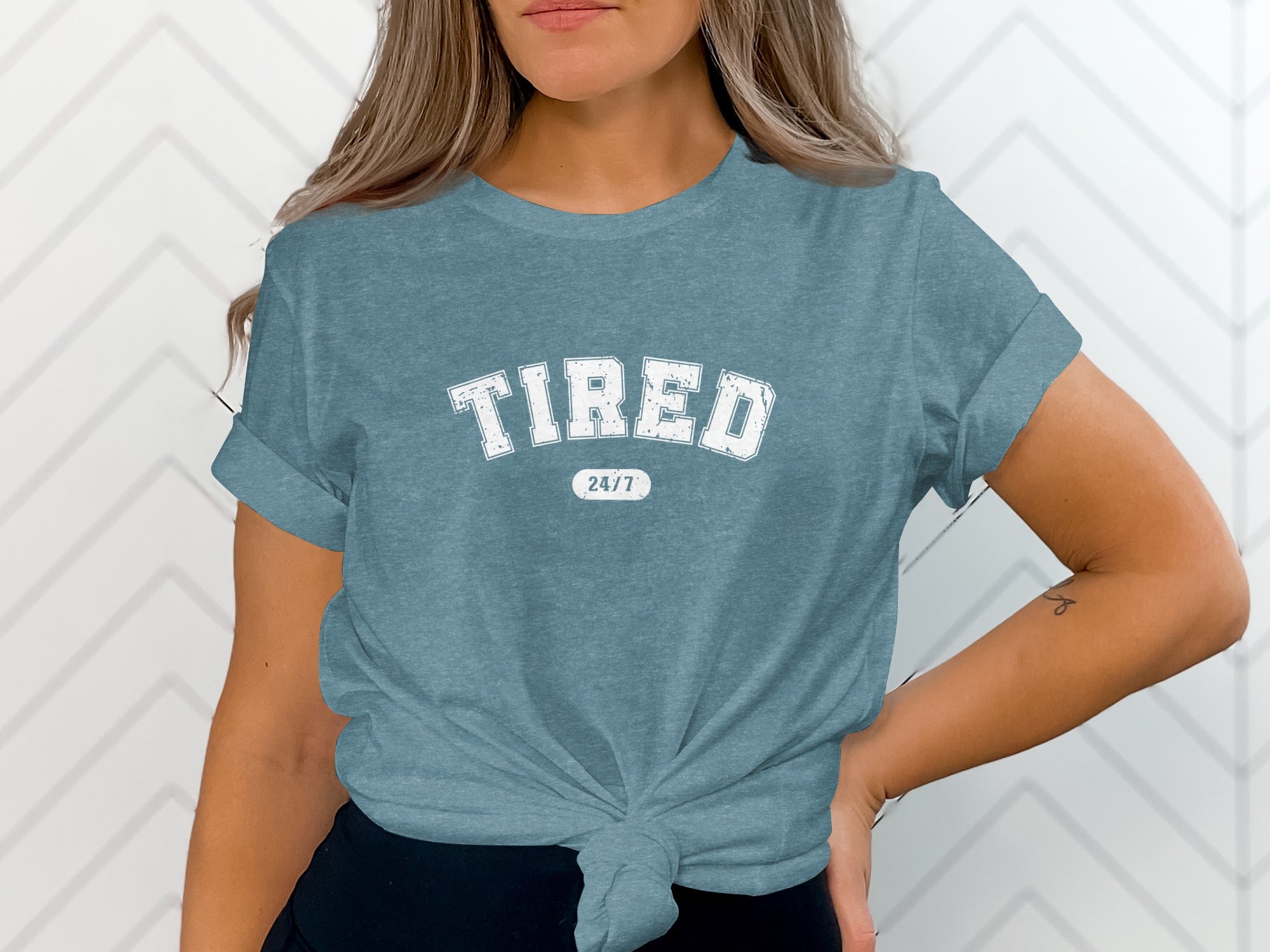 Blue t-shirt with "TIRED 24/7" printed in white uppercase letters.