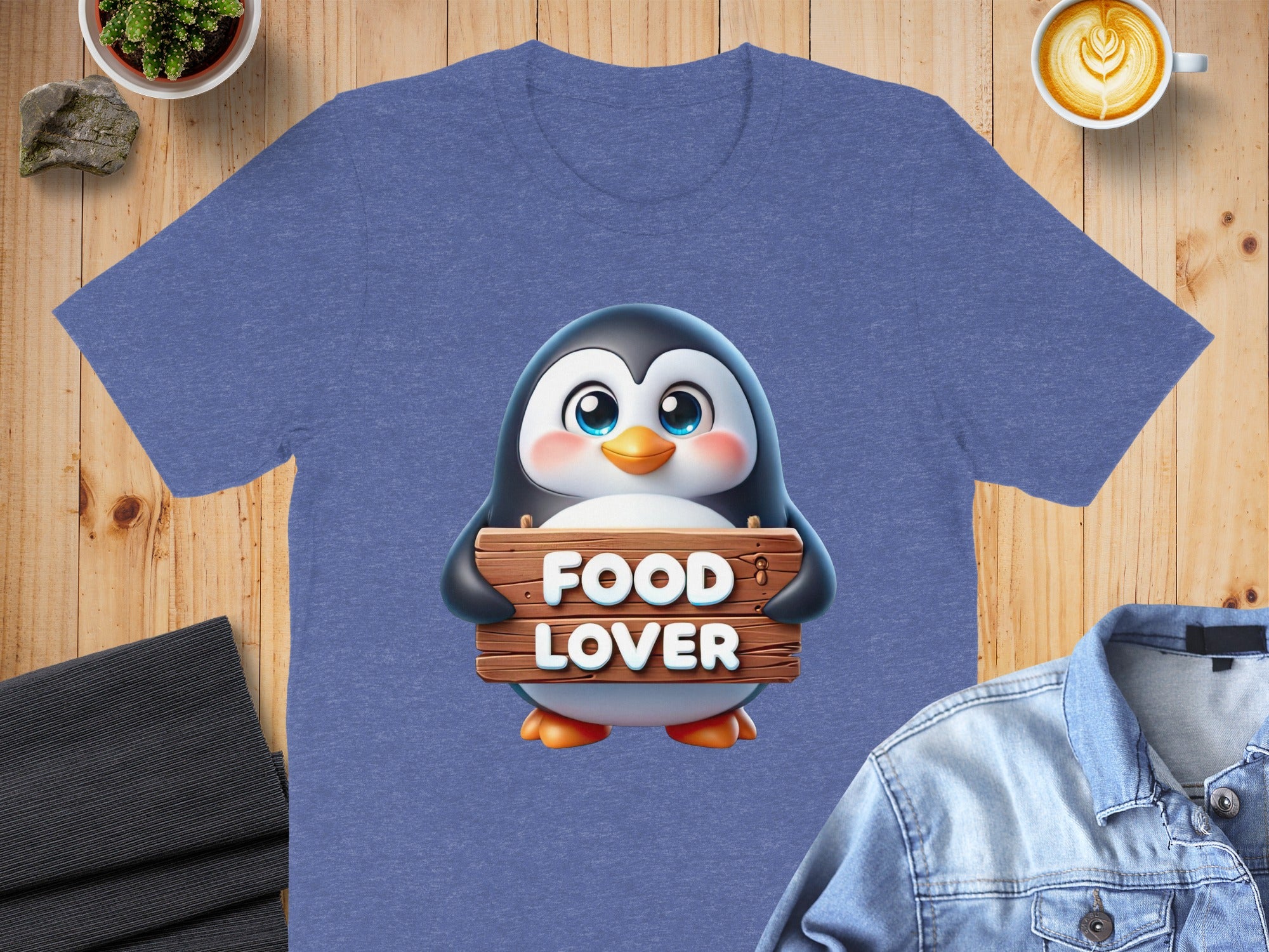 Blue t-shirt with cartoon penguin holding "FOOD LOVER" sign.