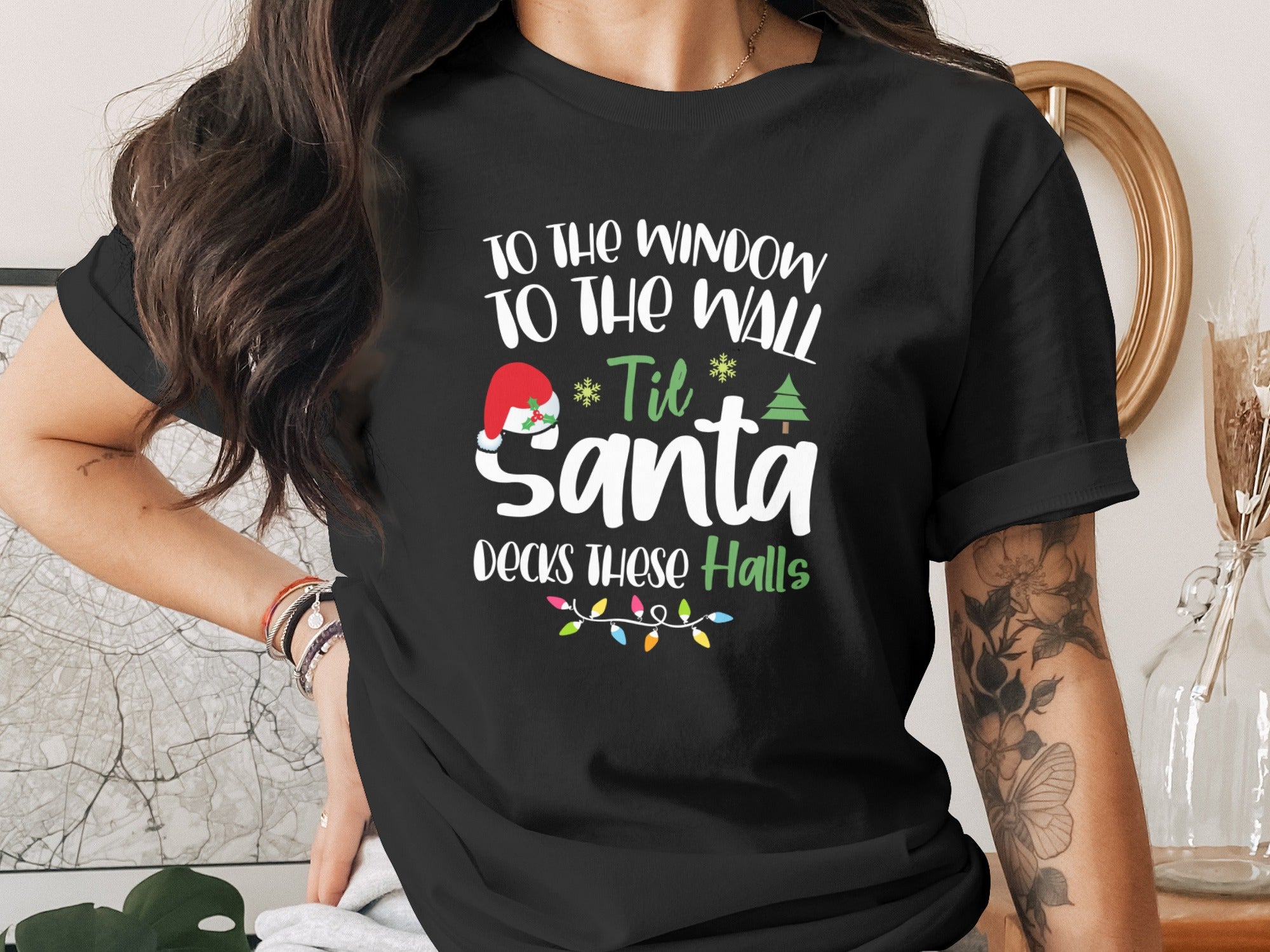 Black t-shirt with "To The Window To The Wall 'Til Santa Decks These Halls" text.