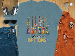Blue t-shirt with colorful brooms and text "A girl's gotta have OPTIONS!"