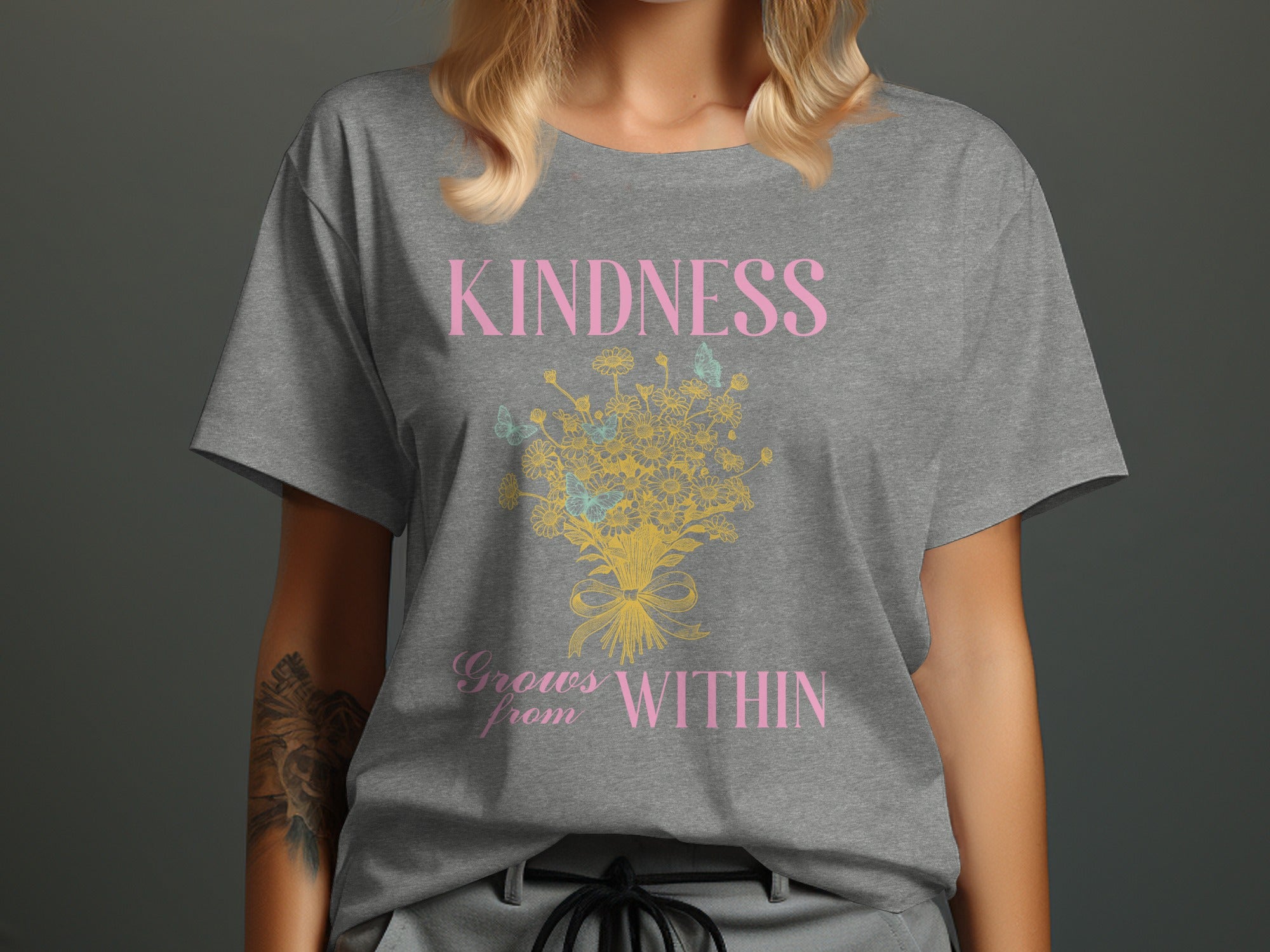 Grey t-shirt with pink text "KINDNESS Grows from WITHIN" and a floral design.