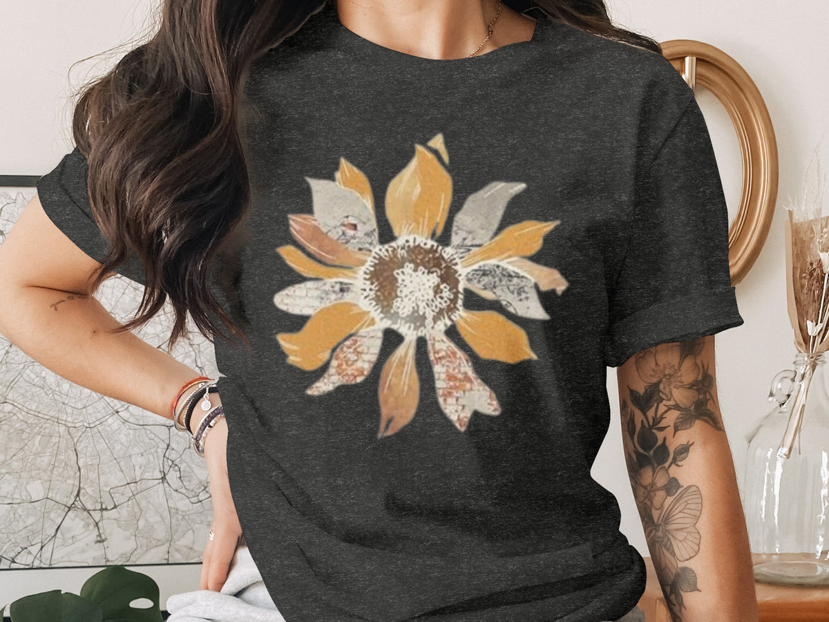Dark grey t-shirt with a collage-style sunflower graphic and floral arm tattoo.