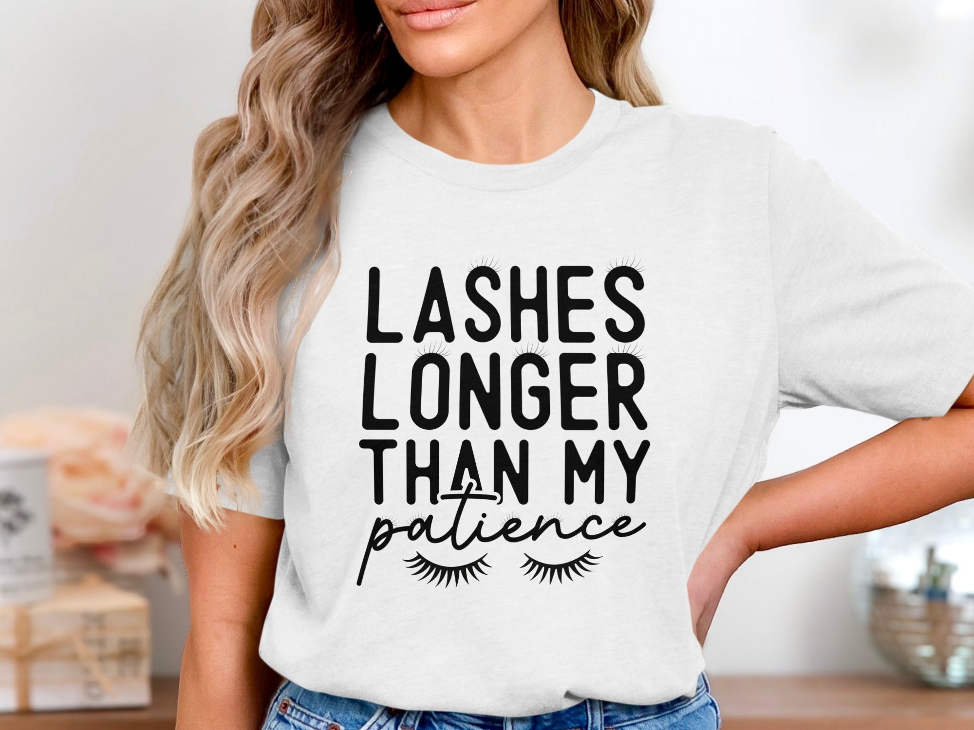 White t-shirt with black text: "LASHES LONGER THAN MY patience" and eyelashes.
