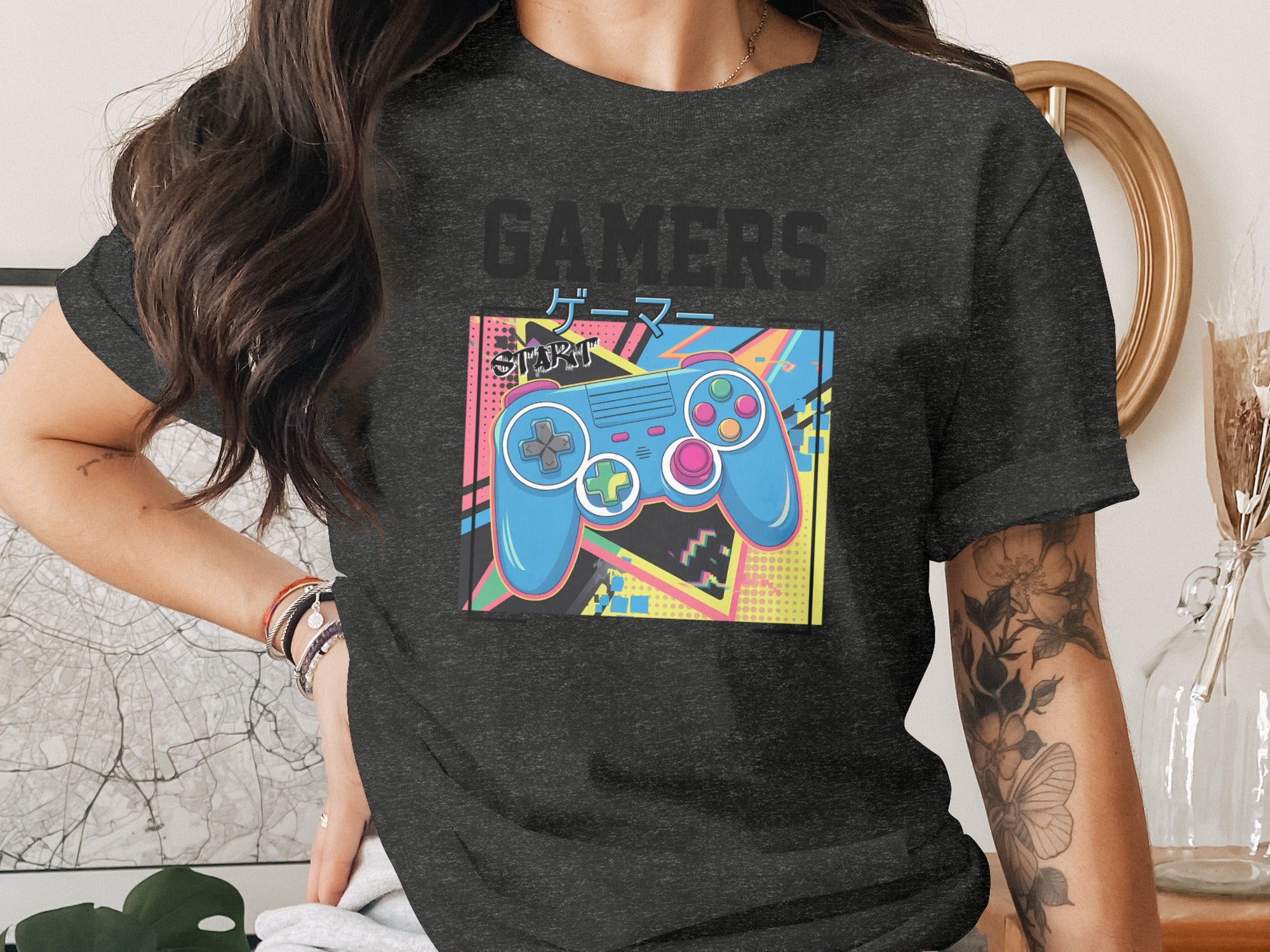 Dark t-shirt with vintage-style graphic featuring a blue video game controller and the word "GAMERS".