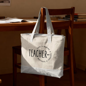 Light colored canvas tote bag with "Teacher" and circular text.
