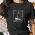 Black t-shirt with "Port Haven Sailing Club" and sailboat graphic.