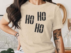 Tan t-shirt with black distressed "HO HO HO" graphic on front.