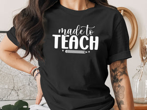 Black t-shirt with "made to TEACH" and a pencil graphic in white.